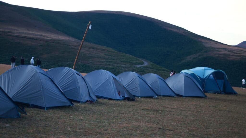 Row of camping tents on a mountain campsite in Koraput, Odisha