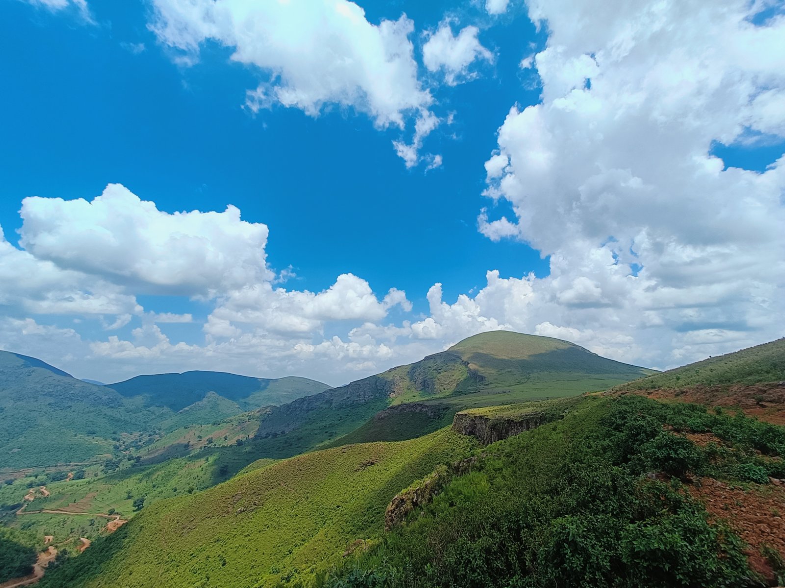 Kalyamali peak in Koraput under a bright blue sky with green slopes